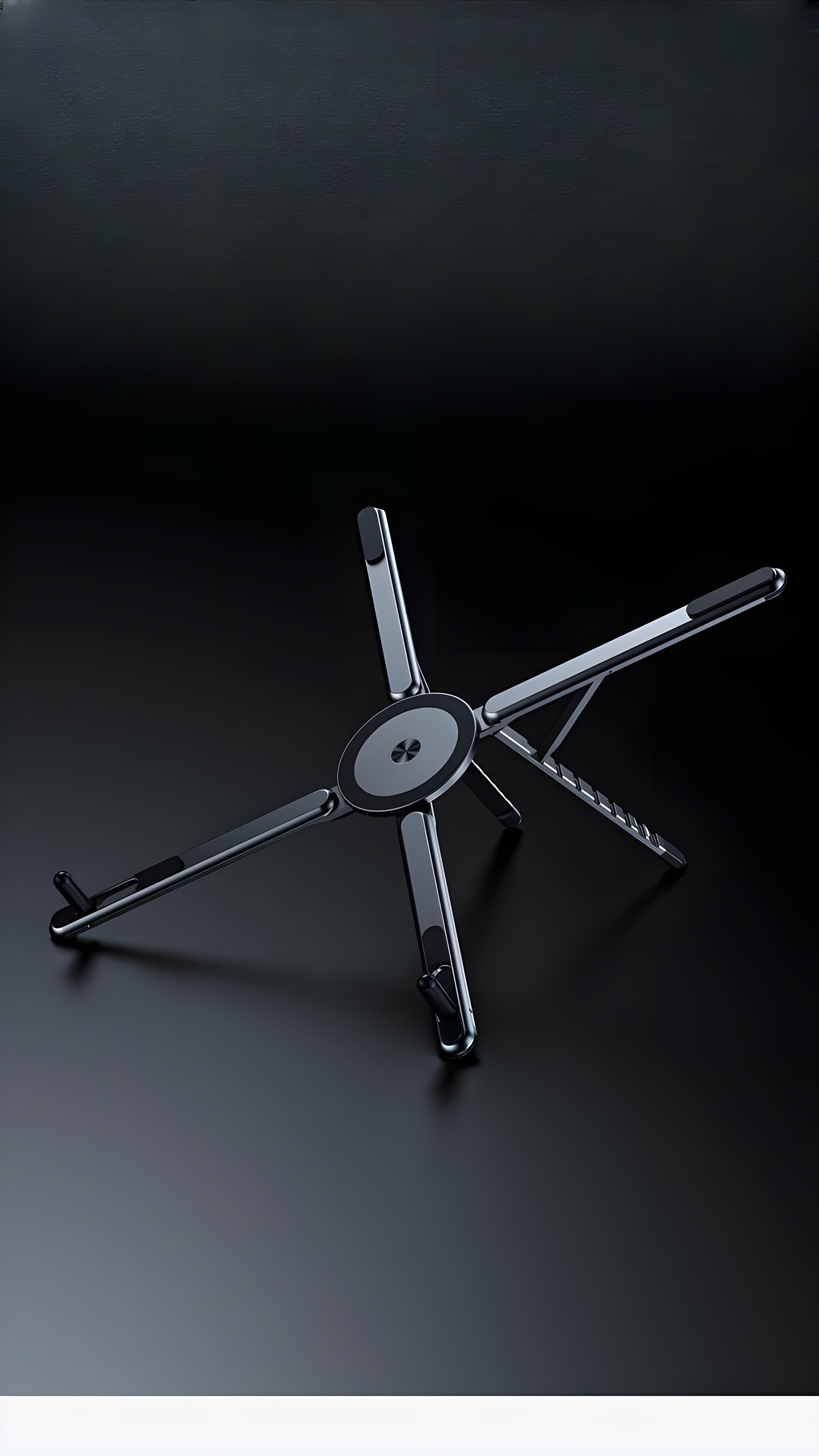 Top-down view of the workstation fully unfolded into its star-like tripod configuration on a dark surface.