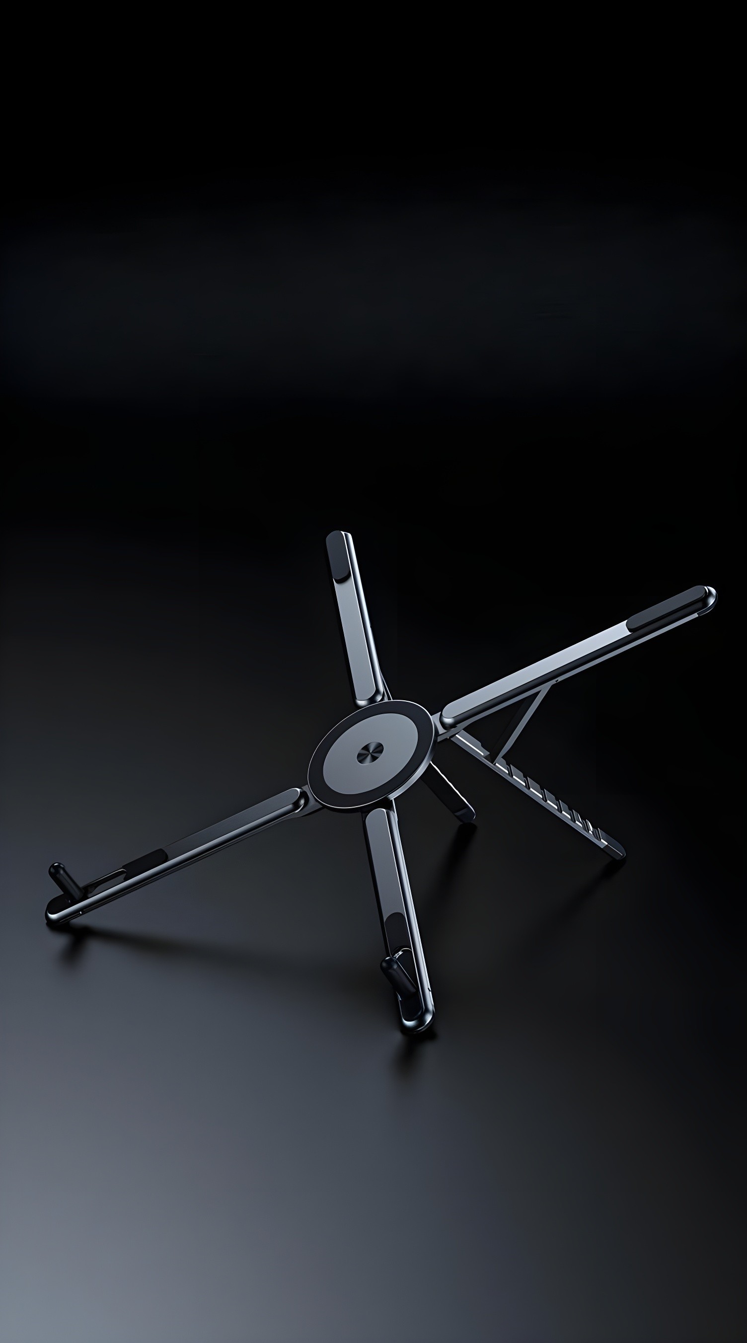 Another top-down view highlighting the central magnetic disc and the four radiating arms of the workstation.