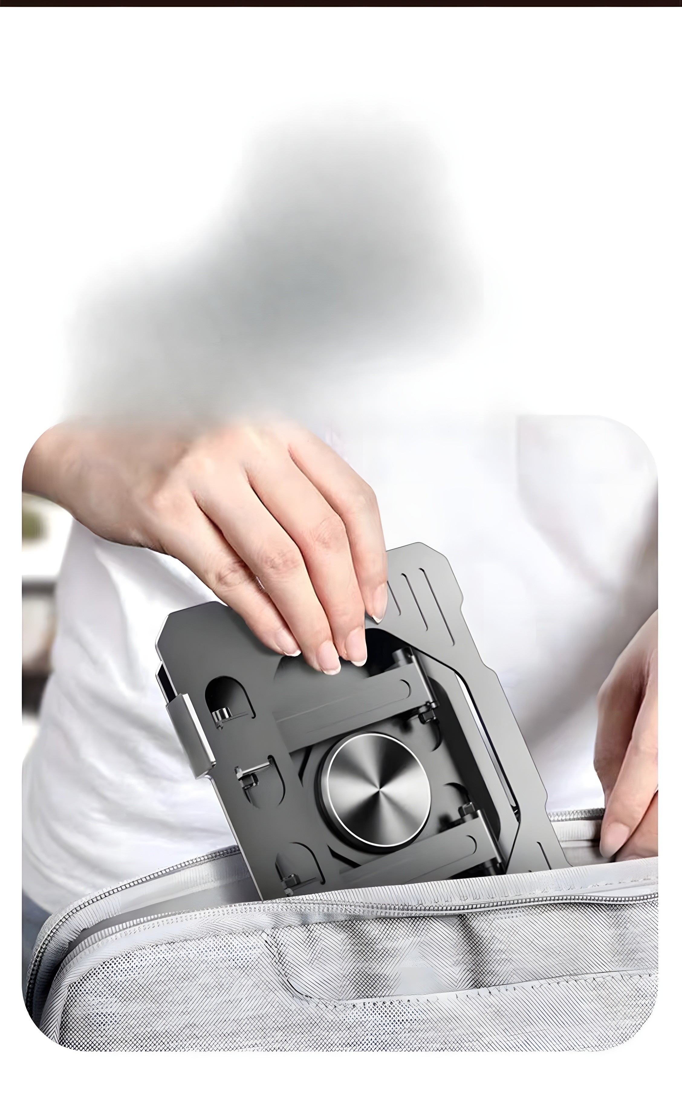 Person folding stand into bag