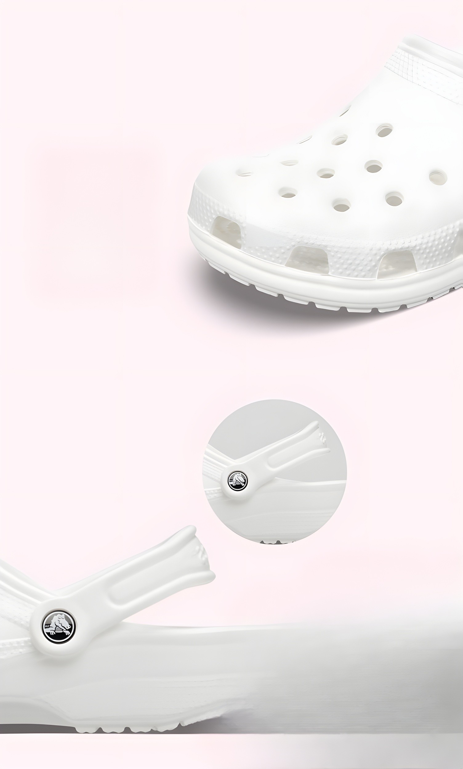 Close-up of a white CROCS clog highlighting the textured sole and the iconic Crocs logo on the heel strap against a soft pink background