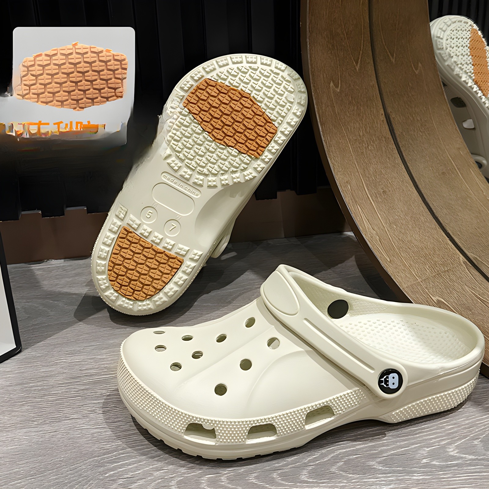 Clog with sole facing up, showing orange textured grip areas